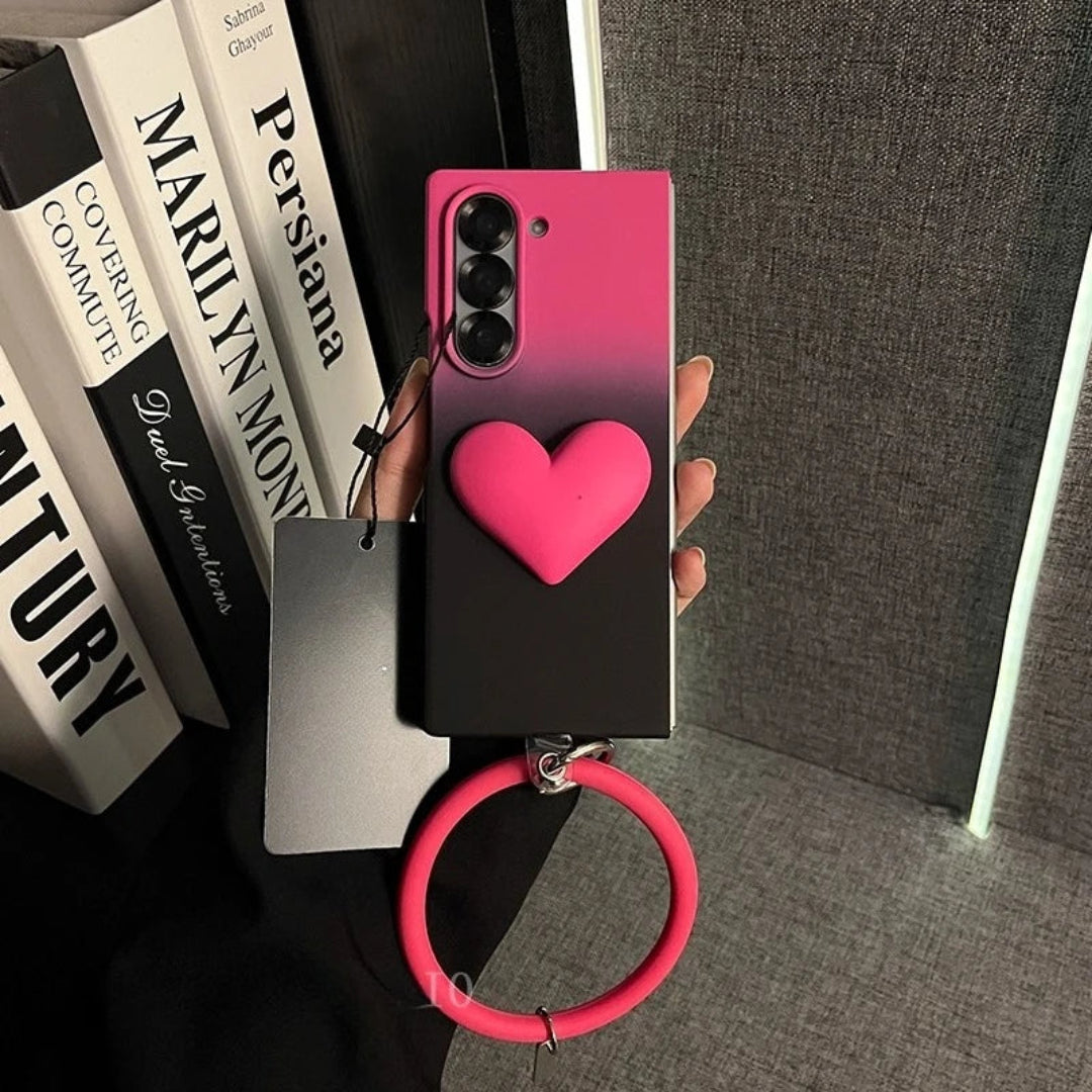 Phone case with pink heart and ring holder held over books