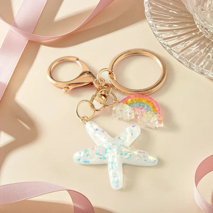 Keychain with star and rainbow charm on a light background