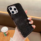 Black rhinestone phone case held by a person with a blurred background
