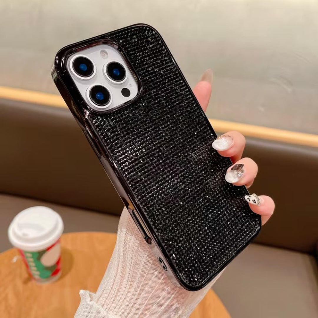 Black rhinestone phone case held by a person with a blurred background