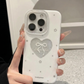 Phone case with heart design held by a person