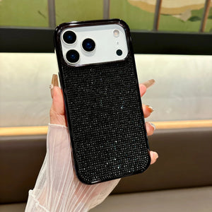 Black textured phone case held by a hand with a blurred indoor background