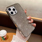 Silver glittery phone case held by a hand with a blurred background